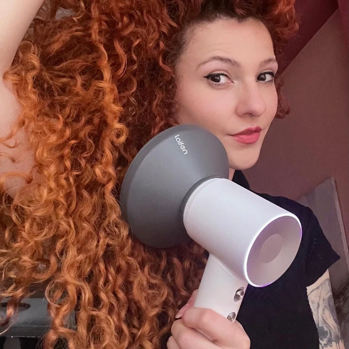 Use a hair dryer with a diffuser to dry curly hair