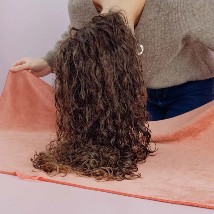 Use a microfiber towel to dry curly hair