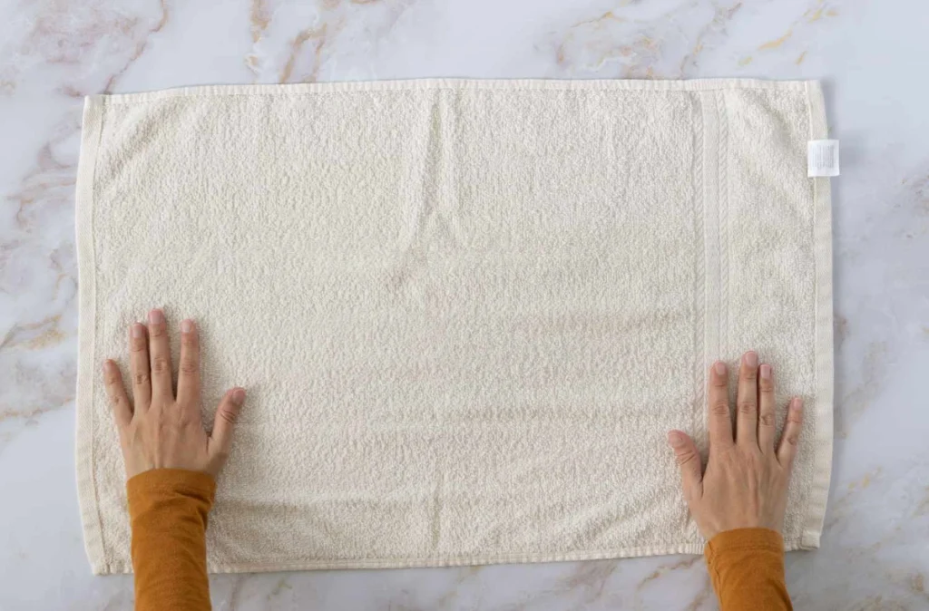 How to wrap hair towel? Lay the towel flat on a flat surface